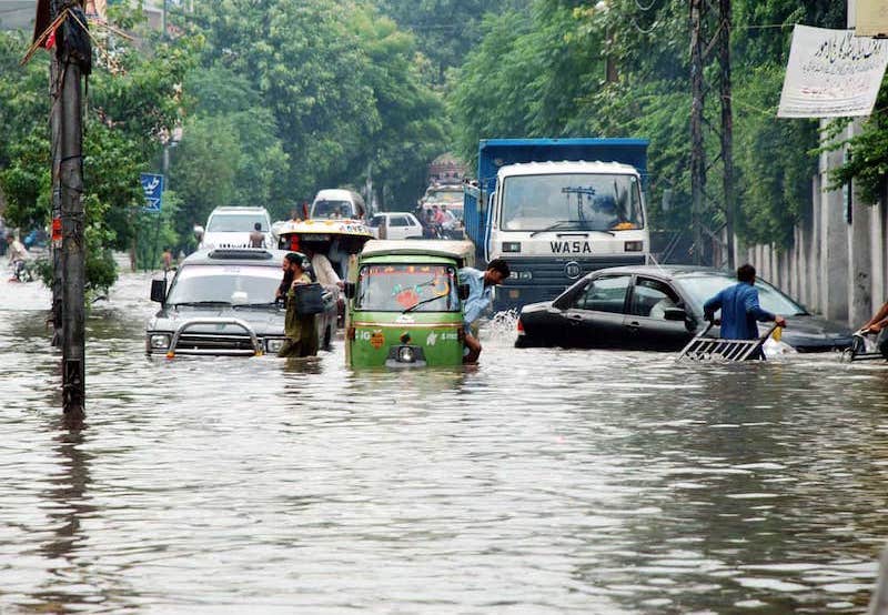 Flooded street in Lahore, Pakistan with water up the the car doors.