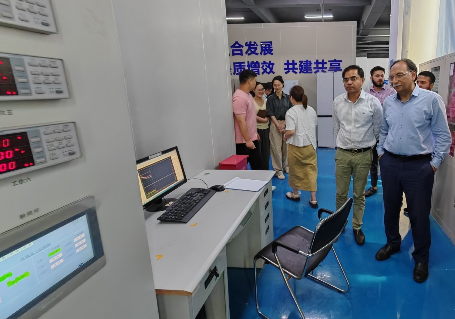 Participants look at testing equipment