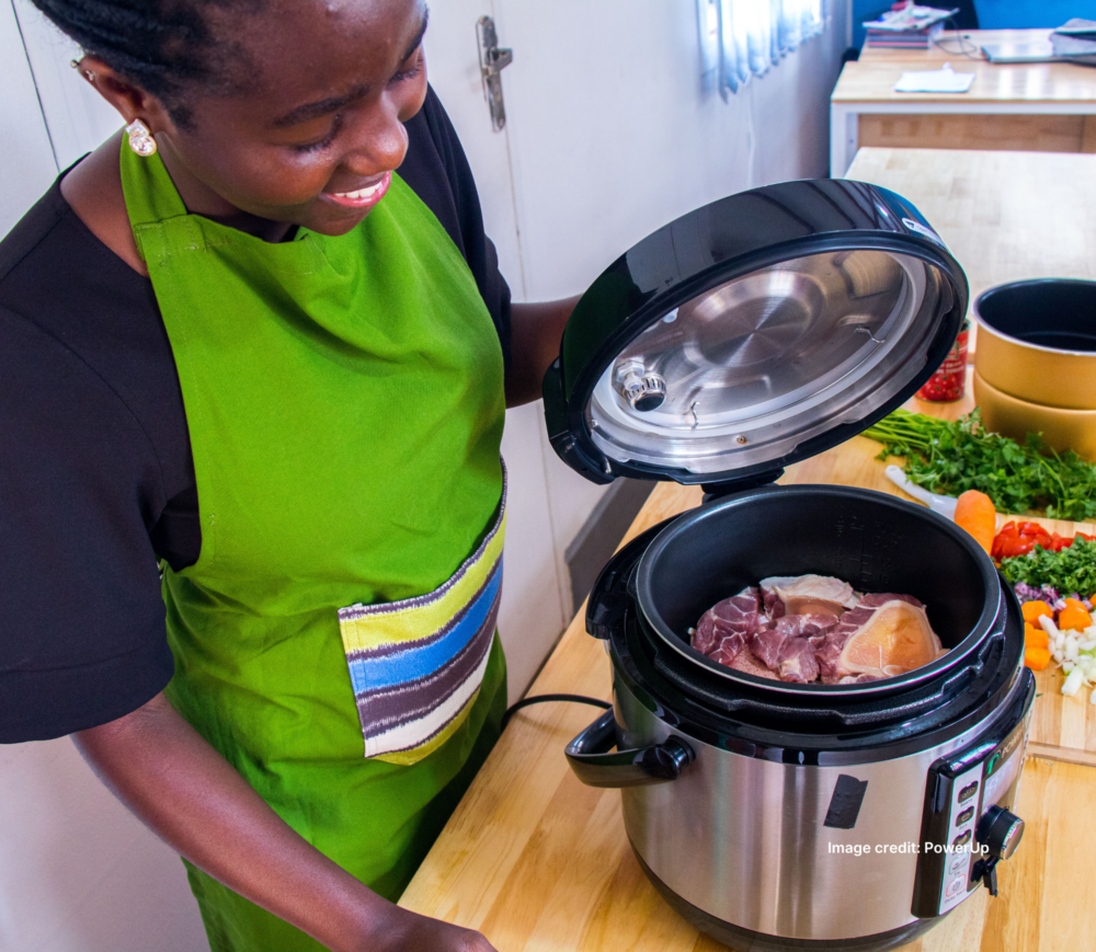 Ugandan woman using a PowerUP electric pressure cooker
