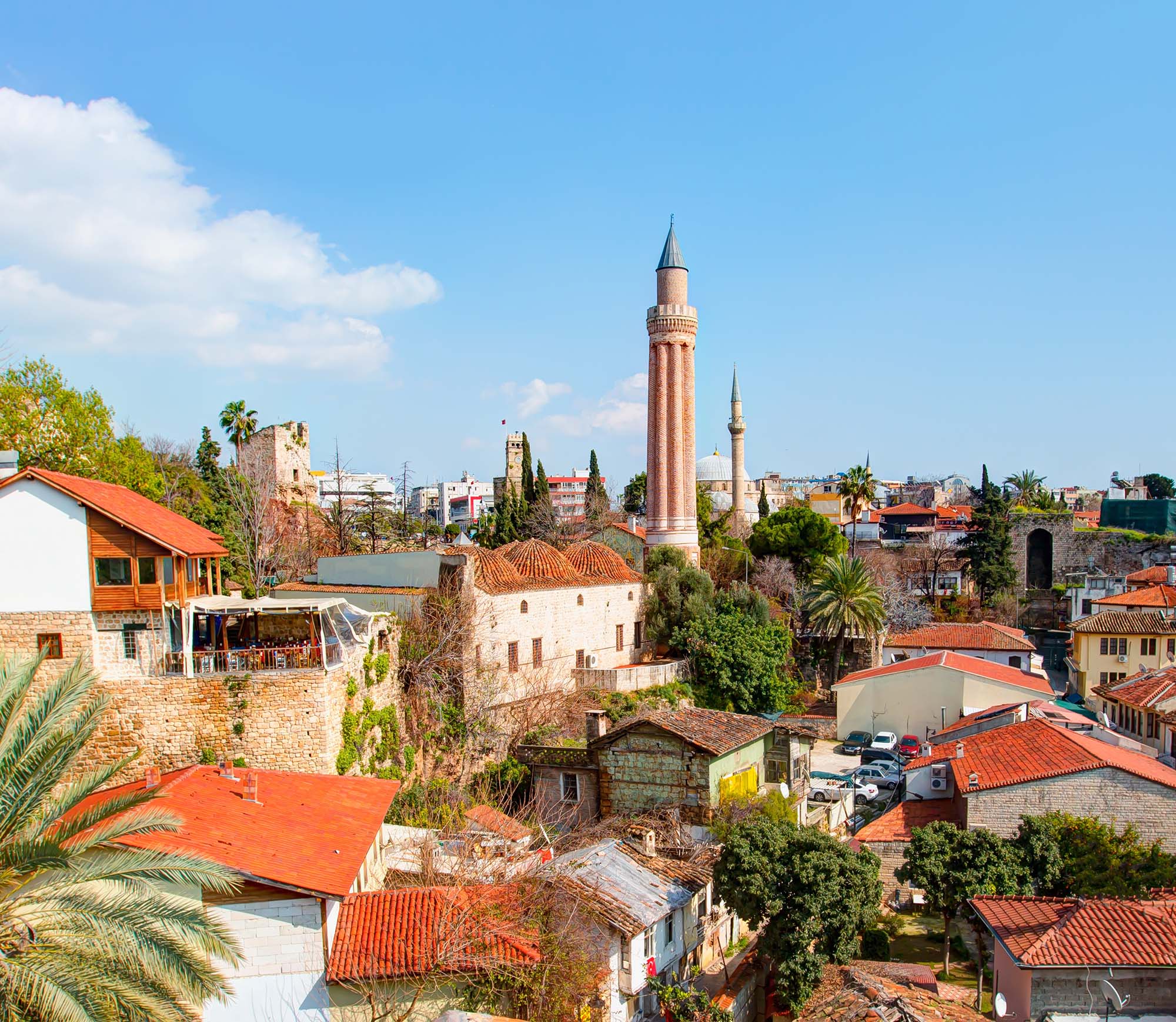 View of town showing low buildings with red roofs.